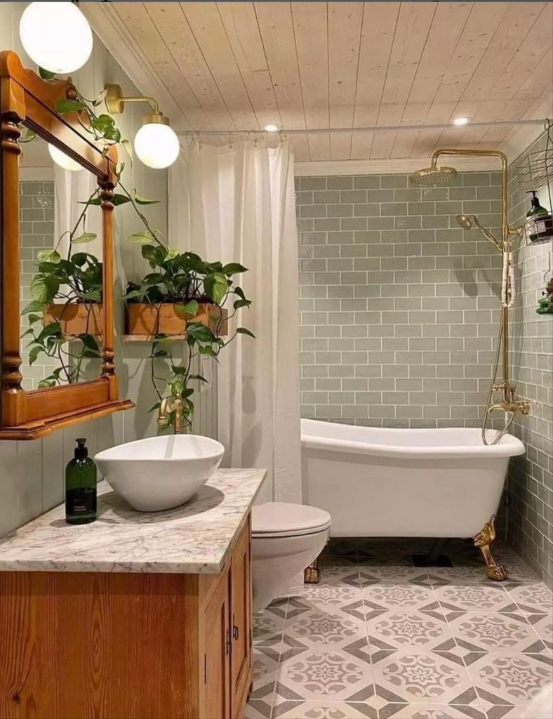 Let's talk about how to decorate the perfect boho bathroom. I noticed some common themes in the bathroom below. They feature houseplants, bamboo wood trim, and teal cabinets or tiles. Keep this in mind when looking for trends in boho bathroom design. Use natural materials and try to keep your decor as unpretentious as possible.