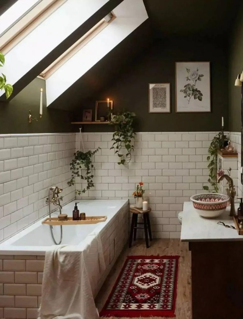 Let's talk about how to decorate the perfect boho bathroom. I noticed some common themes in the bathroom below. They feature houseplants, bamboo wood trim, and teal cabinets or tiles. Keep this in mind when looking for trends in boho bathroom design. Use natural materials and try to keep your decor as unpretentious as possible.