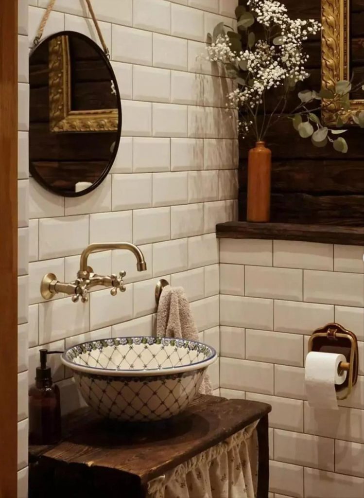 Let's talk about how to decorate the perfect boho bathroom. I noticed some common themes in the bathroom below. They feature houseplants, bamboo wood trim, and teal cabinets or tiles. Keep this in mind when looking for trends in boho bathroom design. Use natural materials and try to keep your decor as unpretentious as possible.