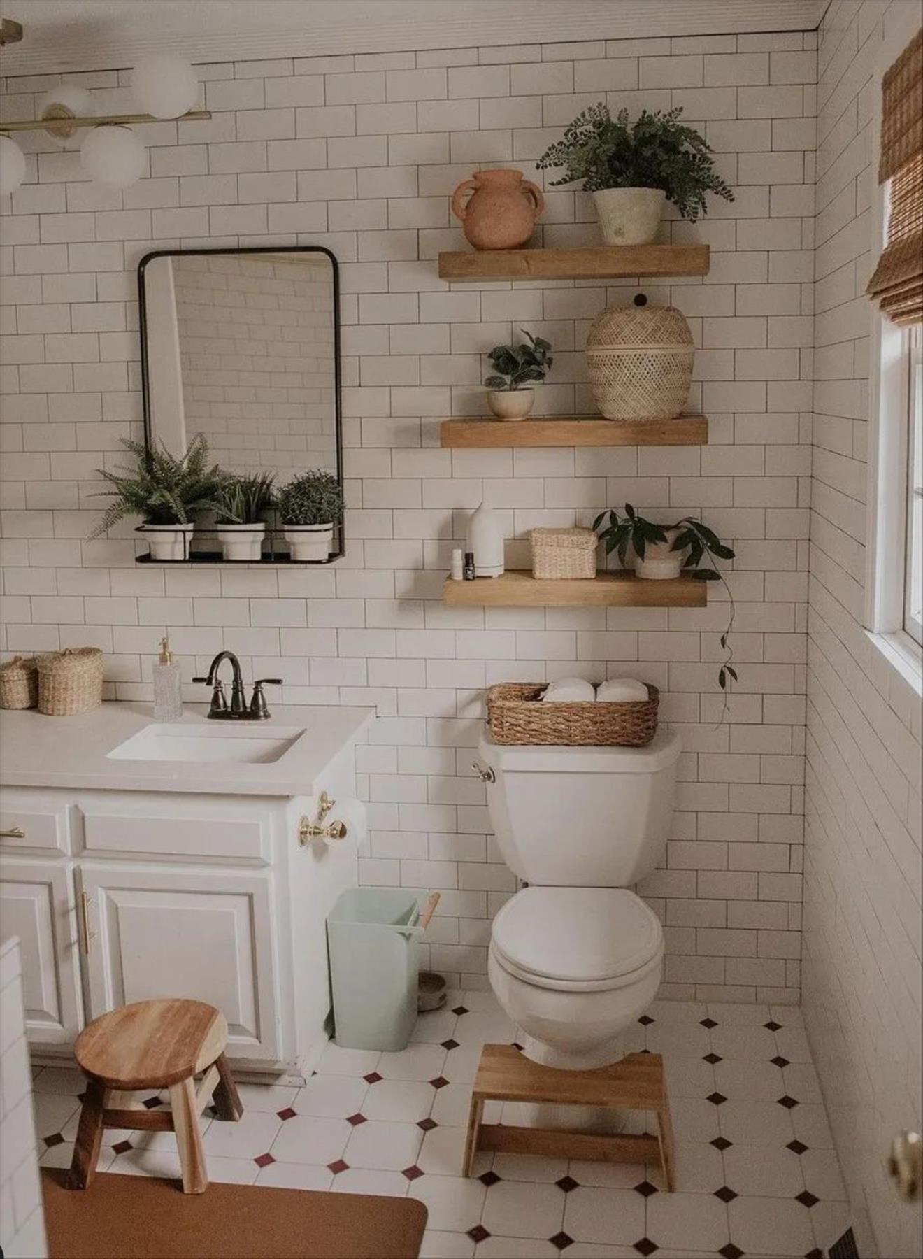 Let's talk about how to decorate the perfect boho bathroom. I noticed some common themes in the bathroom below. They feature houseplants, bamboo wood trim, and teal cabinets or tiles. Keep this in mind when looking for trends in boho bathroom design. Use natural materials and try to keep your decor as unpretentious as possible.
