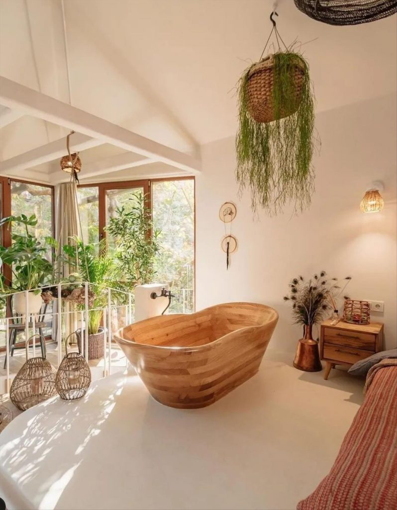 Let's talk about how to decorate the perfect boho bathroom. I noticed some common themes in the bathroom below. They feature houseplants, bamboo wood trim, and teal cabinets or tiles. Keep this in mind when looking for trends in boho bathroom design. Use natural materials and try to keep your decor as unpretentious as possible.