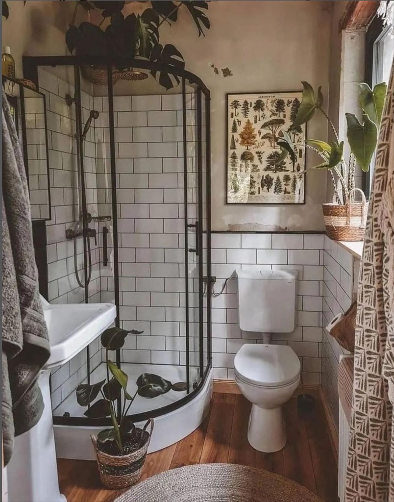 Let's talk about how to decorate the perfect boho bathroom. I noticed some common themes in the bathroom below. They feature houseplants, bamboo wood trim, and teal cabinets or tiles. Keep this in mind when looking for trends in boho bathroom design. Use natural materials and try to keep your decor as unpretentious as possible.