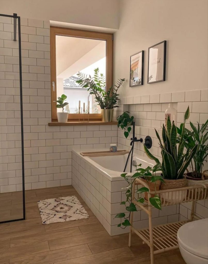 Let's talk about how to decorate the perfect boho bathroom. I noticed some common themes in the bathroom below. They feature houseplants, bamboo wood trim, and teal cabinets or tiles. Keep this in mind when looking for trends in boho bathroom design. Use natural materials and try to keep your decor as unpretentious as possible.