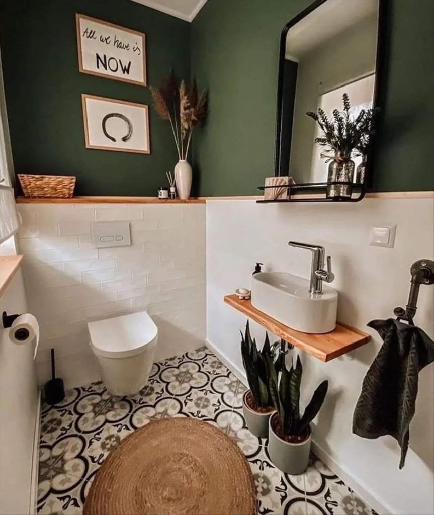 Let's talk about how to decorate the perfect boho bathroom. I noticed some common themes in the bathroom below. They feature houseplants, bamboo wood trim, and teal cabinets or tiles. Keep this in mind when looking for trends in boho bathroom design. Use natural materials and try to keep your decor as unpretentious as possible.