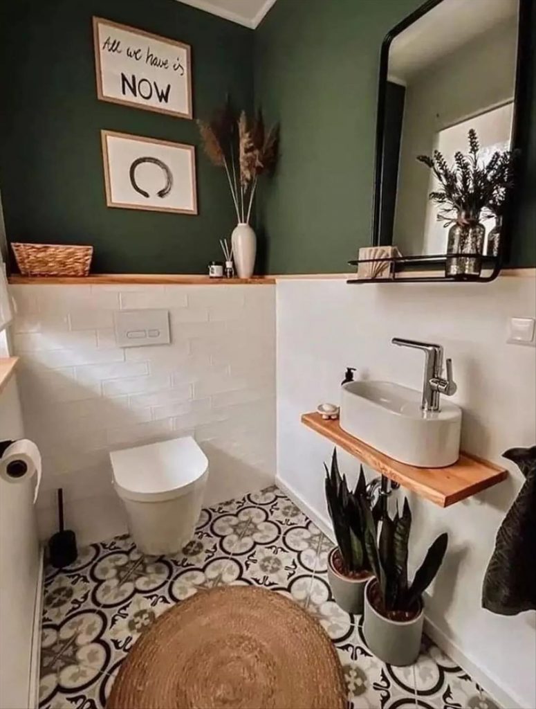 Let's talk about how to decorate the perfect boho bathroom. I noticed some common themes in the bathroom below. They feature houseplants, bamboo wood trim, and teal cabinets or tiles. Keep this in mind when looking for trends in boho bathroom design. Use natural materials and try to keep your decor as unpretentious as possible.