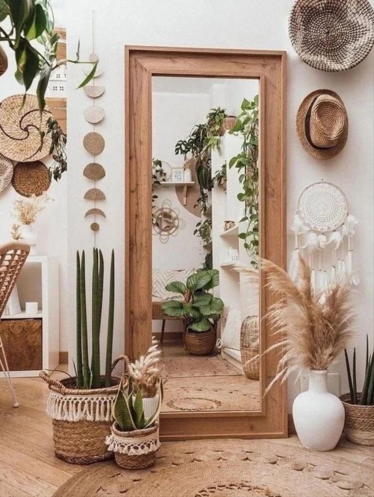 Let's talk about how to decorate the perfect boho bathroom. I noticed some common themes in the bathroom below. They feature houseplants, bamboo wood trim, and teal cabinets or tiles. Keep this in mind when looking for trends in boho bathroom design. Use natural materials and try to keep your decor as unpretentious as possible.