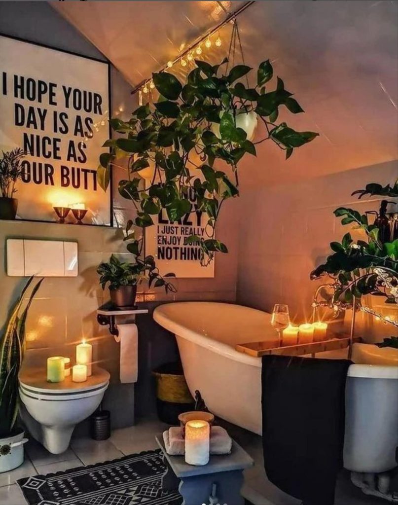 Let's talk about how to decorate the perfect boho bathroom. I noticed some common themes in the bathroom below. They feature houseplants, bamboo wood trim, and teal cabinets or tiles. Keep this in mind when looking for trends in boho bathroom design. Use natural materials and try to keep your decor as unpretentious as possible.